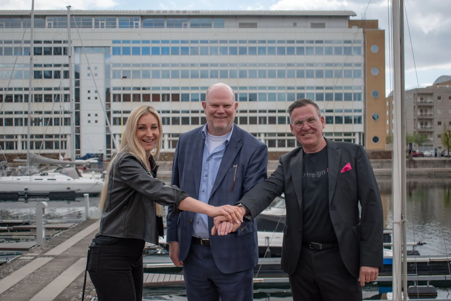 Handshake marking the partnership between CC-Interactive and T-Systems, with CEO Harald Riis Thomsen in the centre